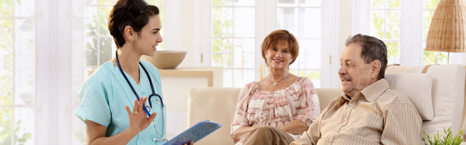 nurse and elderly couple sitting